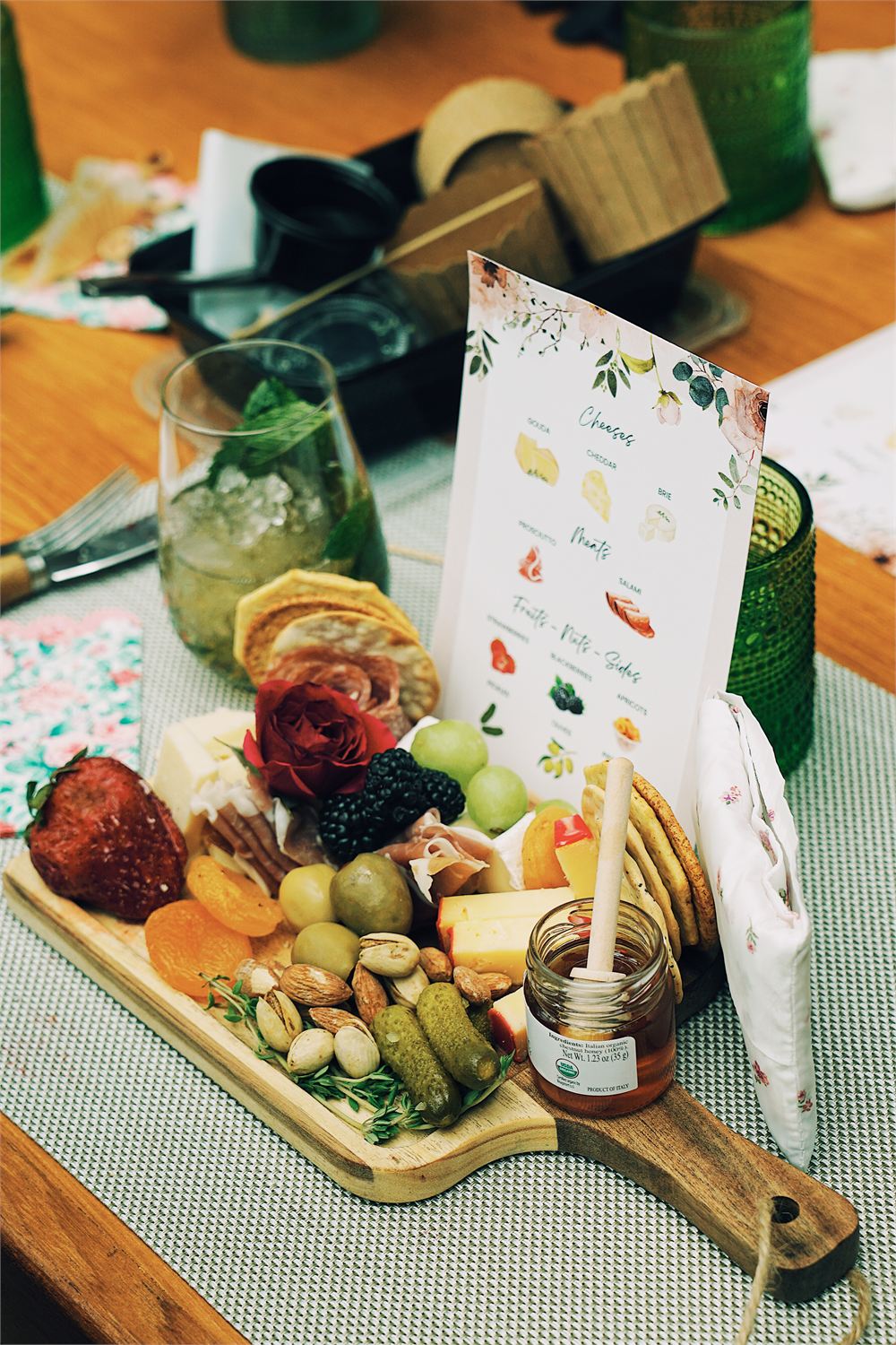 A Graze & Gather styled board with a printed pairing card at an event